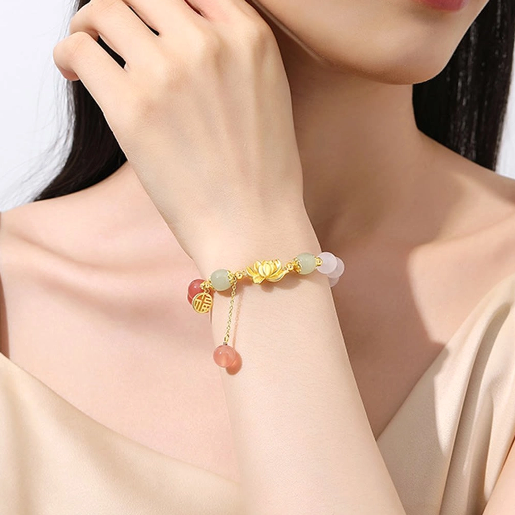 Close-up of Buddhist bracelet worn on hand and neck area, showing how agate and jade beads complement skin tone