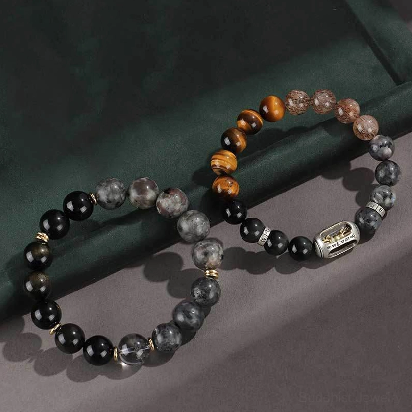 two pairs of beaded buddhist bracelets with dark stones and tiger eye showing size comparison on grey background