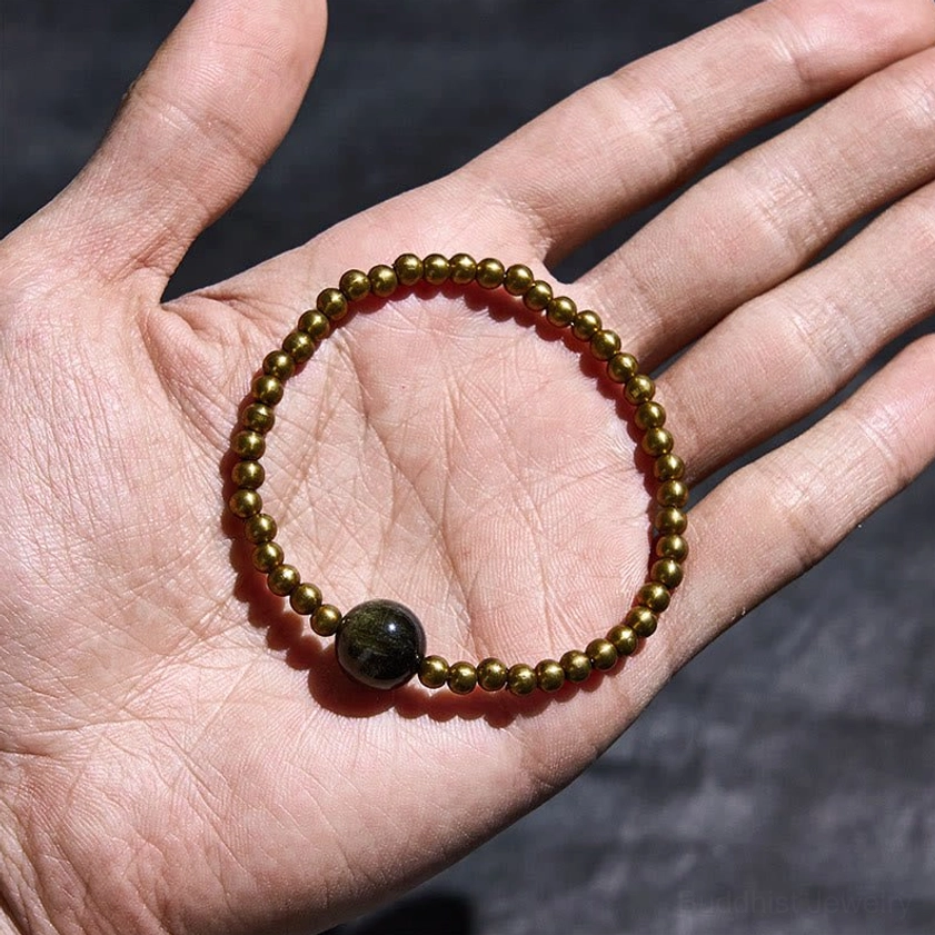 Gold Sheen Obsidian bracelet displayed on palm showing detailed bead arrangement and fit