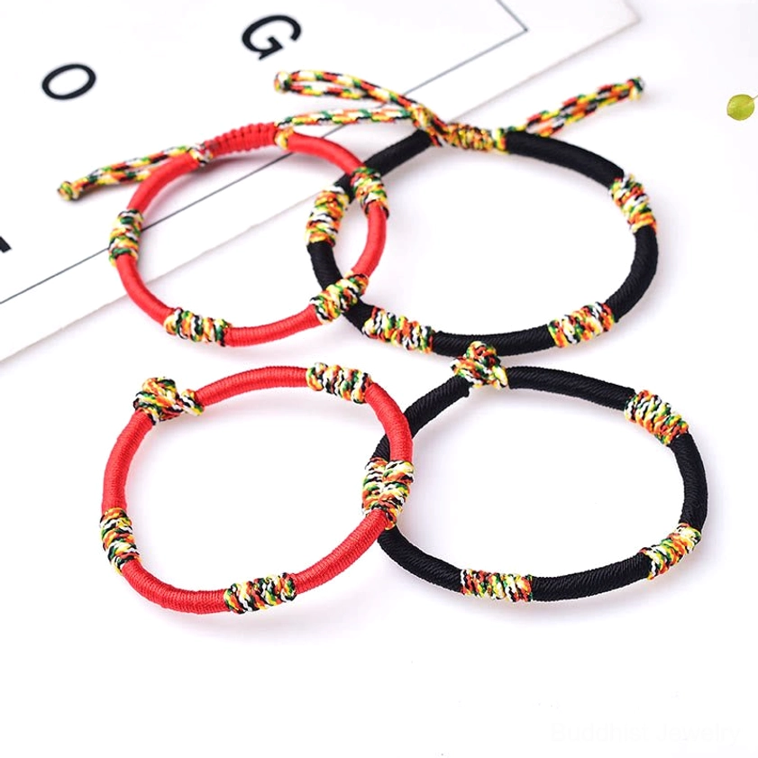 Red and black handmade Buddhist protection bracelets set displaying color options with colorful knot details