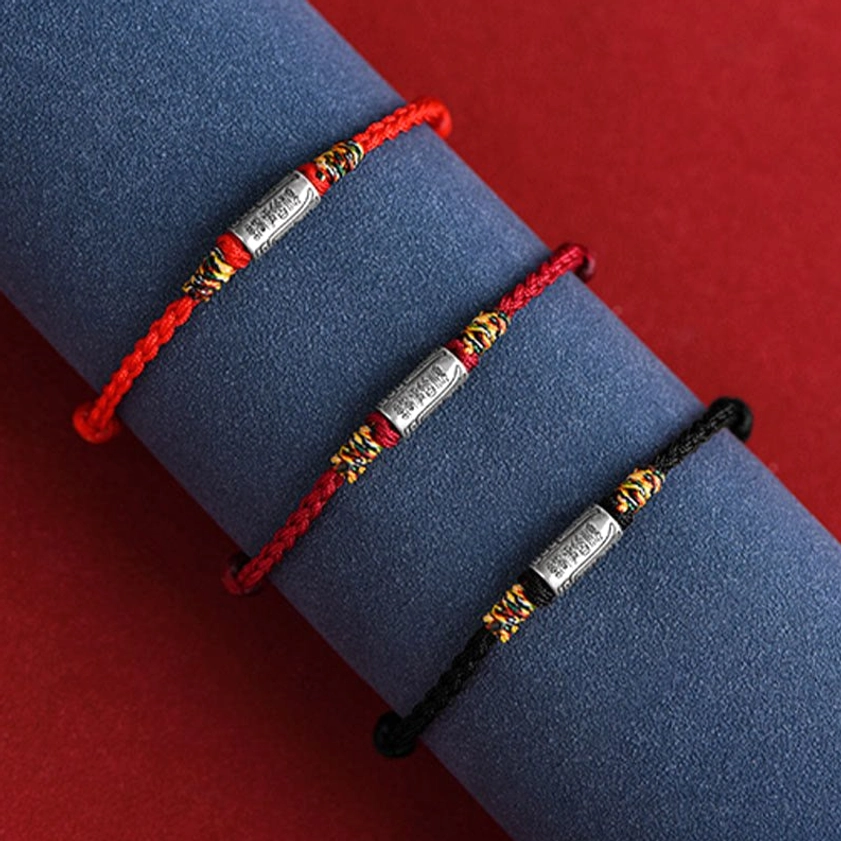 Buddhist blessing bracelet showing rope color variations including red, black, and rainbow options with shared sterling silver charm design