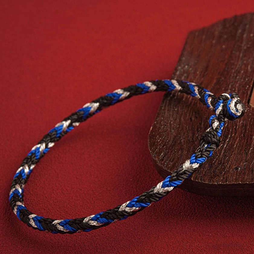 Side view of hand-crafted Buddhist red string bracelet displaying twisted rope texture and King Kong knot