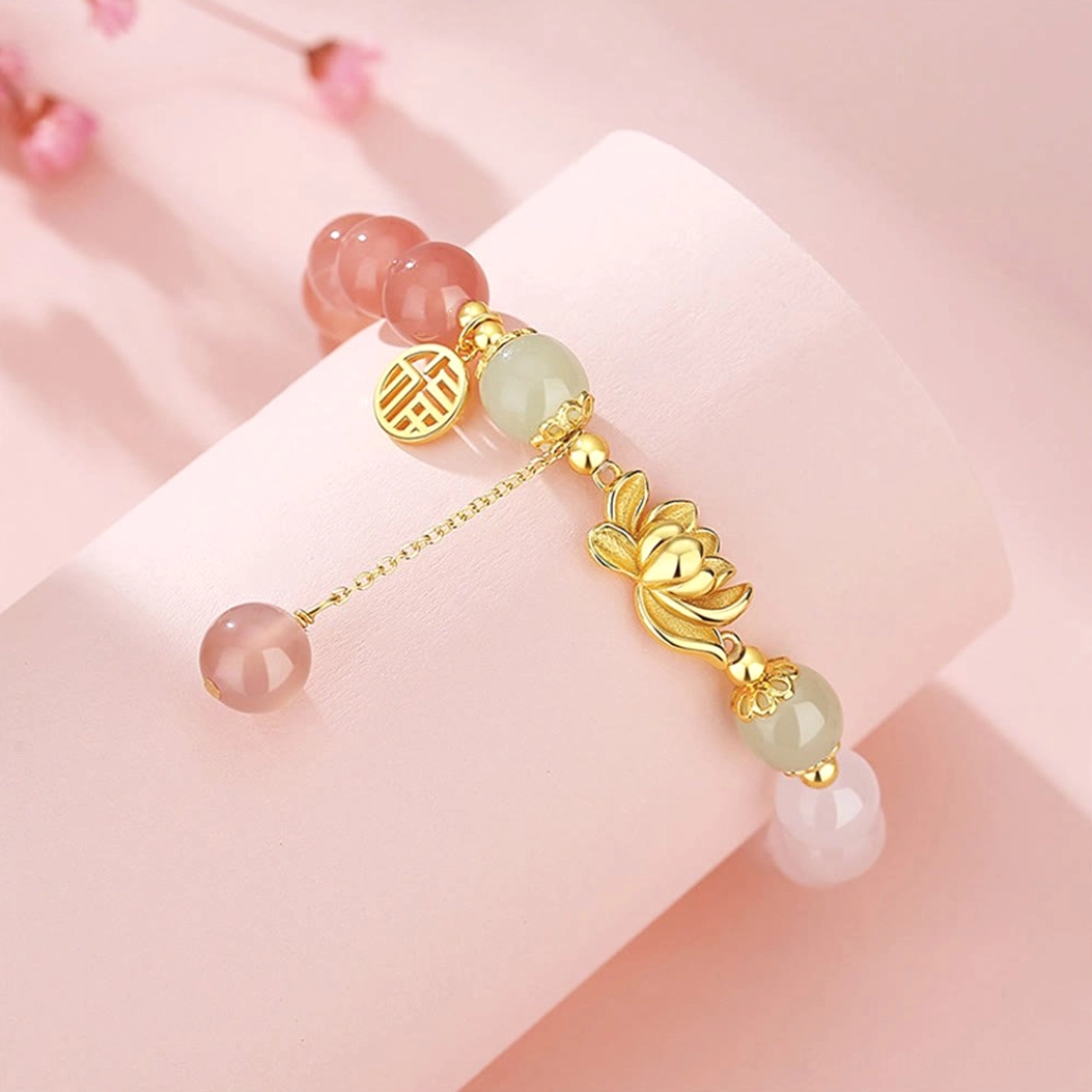 Side angle view of agate lotus Fu bracelet with 925 sterling silver gold-tone charms and dual tassel beads