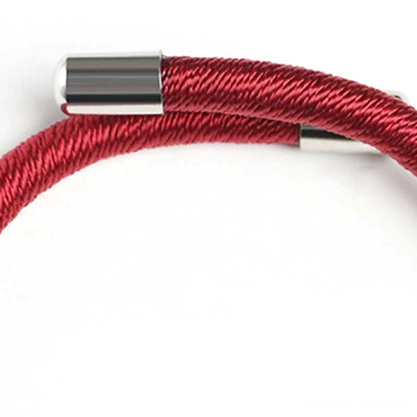 Close-up of red string bracelet ends showing smooth sterling silver metal clasps and woven cord