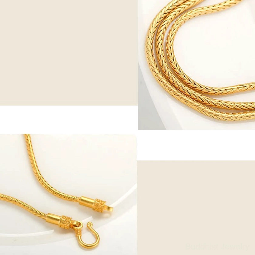 Close-up detail of twisted gold snake chain on Buddhist charm bracelet