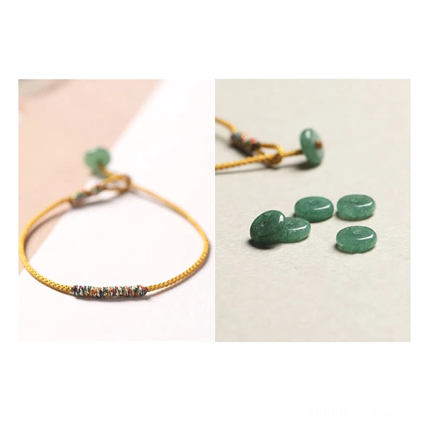 Yellow Buddhist string bracelet displayed with loose green aventurine gemstone beads on soft light background, natural materials showcase