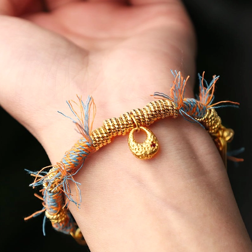 Handmade Buddhist string bracelet worn on human wrist showing actual wearing effect and how the multicolor braided design sits comfortably for daily spiritual practice