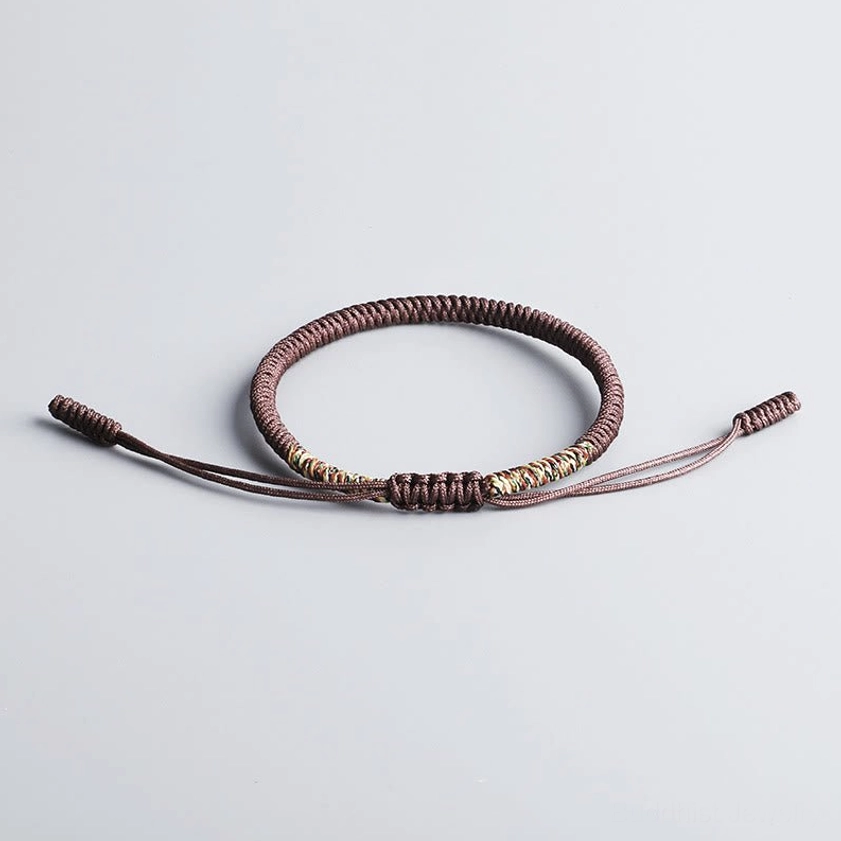 Authentic Buddhist braided bracelet with adjustable cord ends and decorative knot work for spiritual protection and good fortune