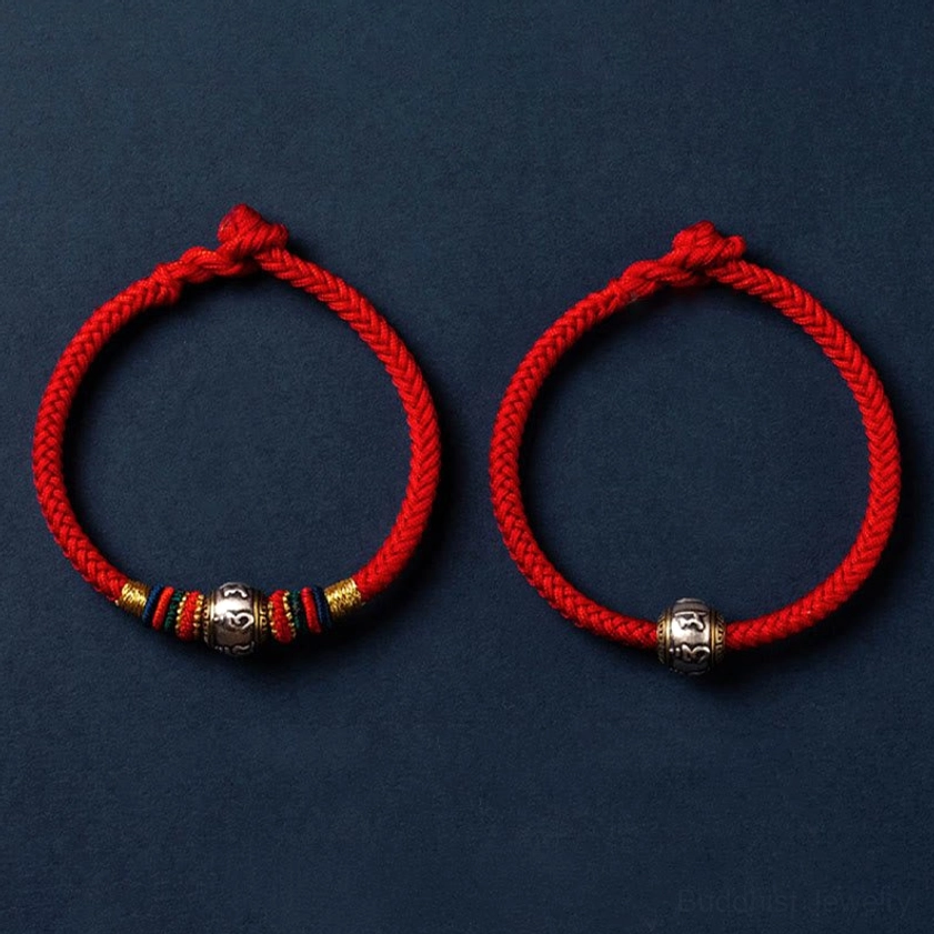 Buddhist braided string bracelet with adjustable sizing, colorful woven pattern, and silver decorative spiritual charm