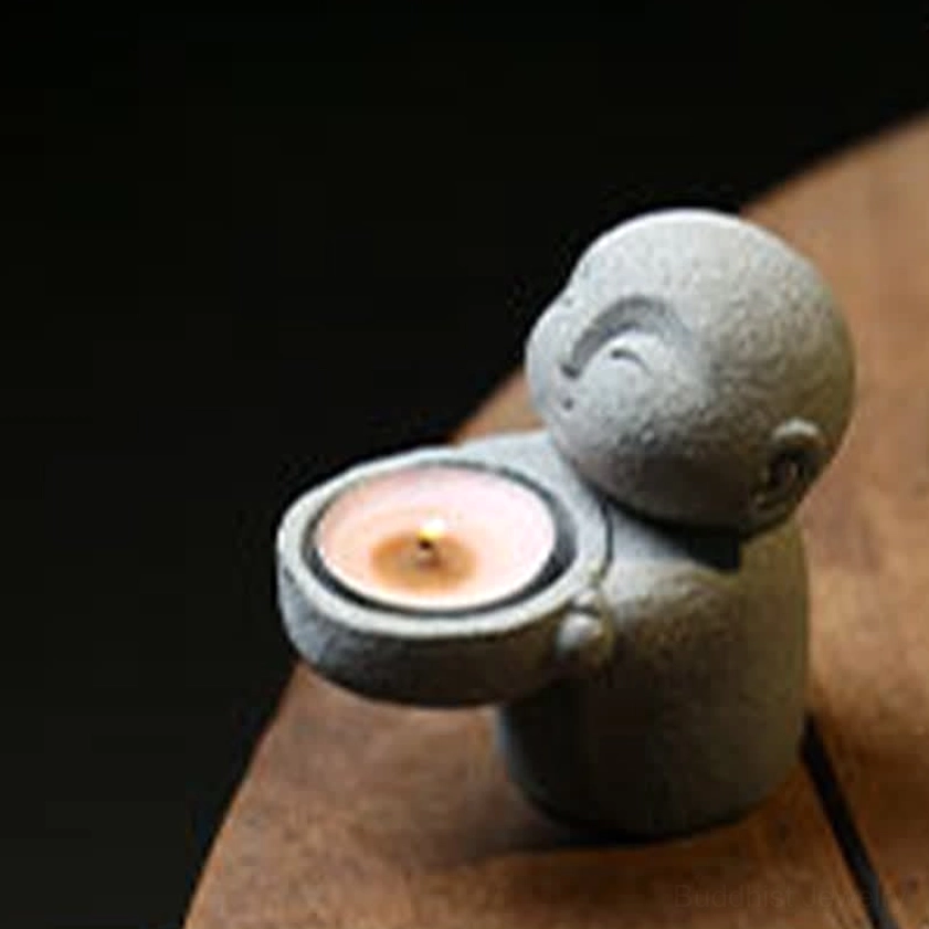 Resin monk tealight holder close-up right side - stone texture detail on wooden surface