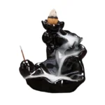 Glossy black ceramic backflow incense holder with lotus waterfall design, front angled view on white background