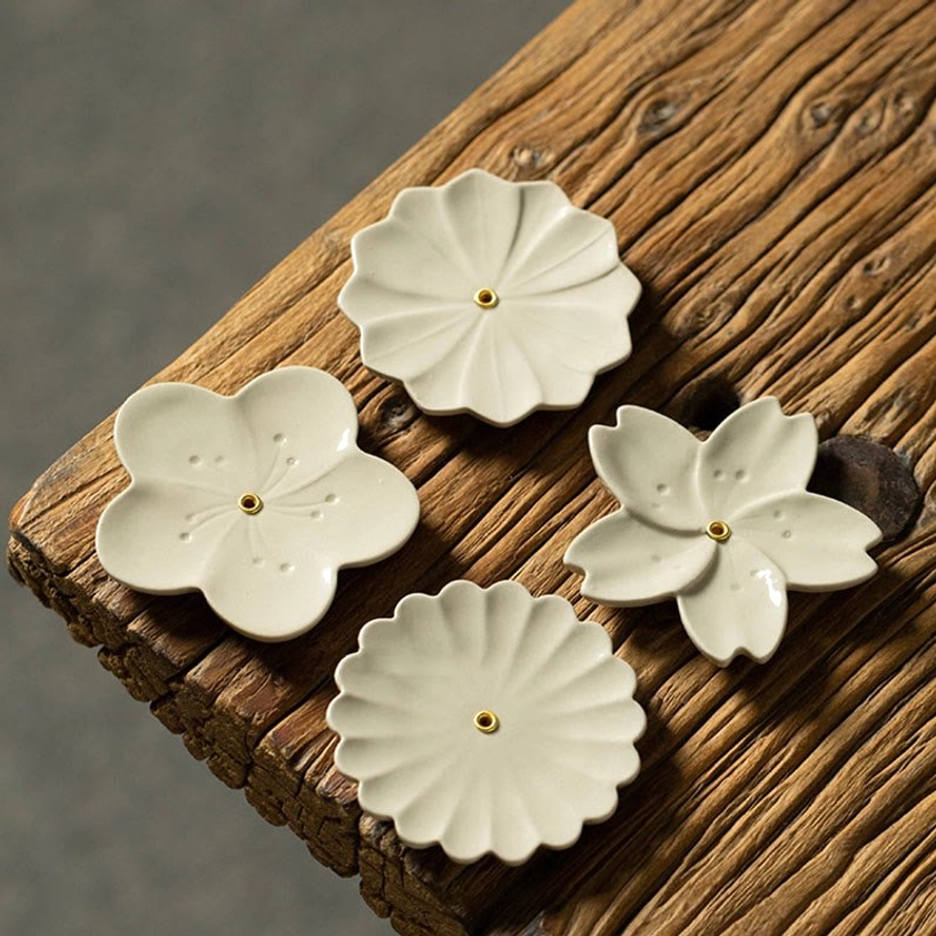Buddhist ceramic incense burner collection flatlay showing all four floral design variants