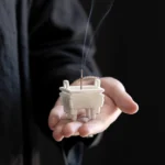 Handcrafted Buddhist ceramic incense burner with Prosperous Dragon pattern, matte white finish, showing burning incense with aromatic smoke rising