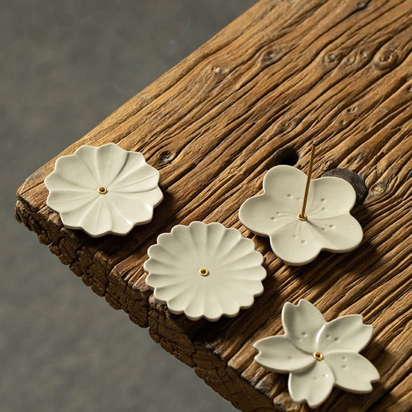 Buddhist floral ceramic incense holder on meditation altar or sacred space setup