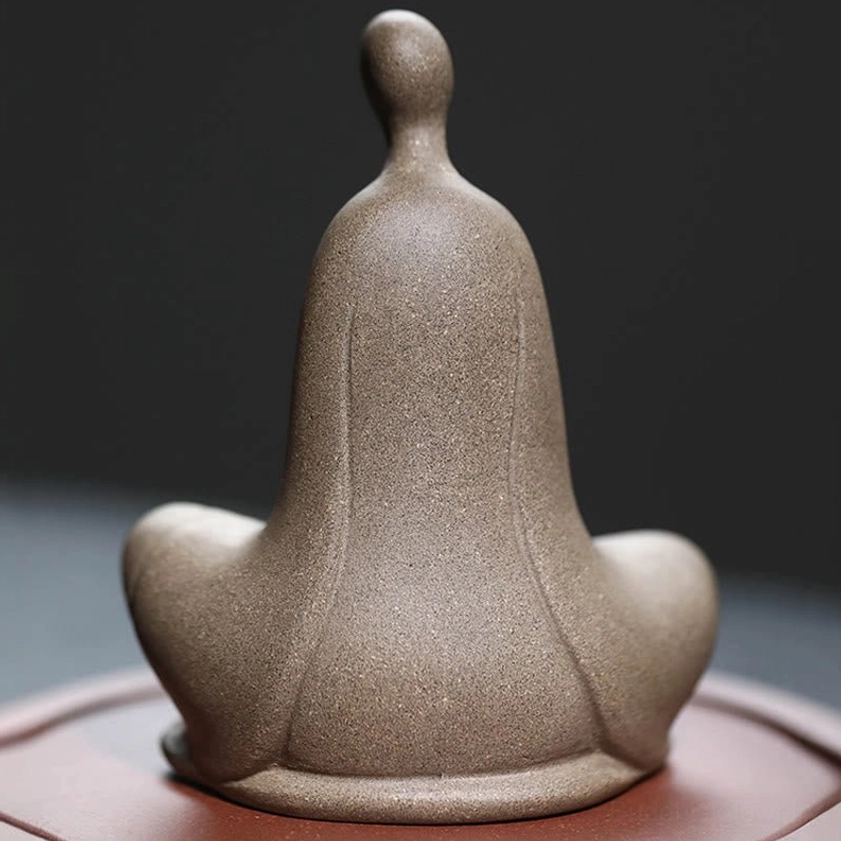 Buddhist ceramic meditation statue - rear angle displaying engraved base and flowing robe design