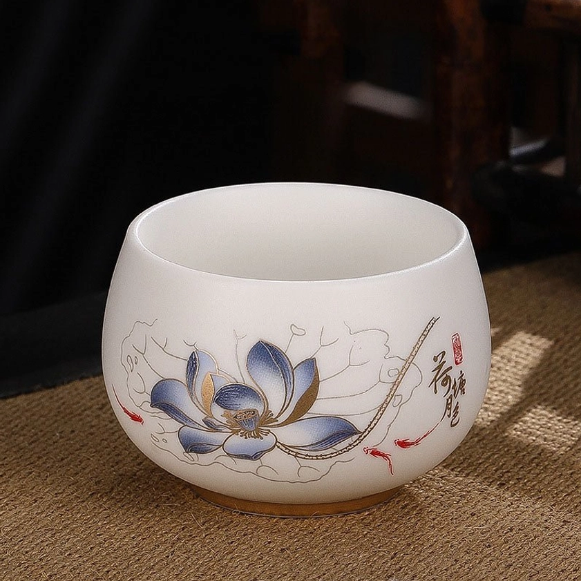 Blue lotus flower ceramic tea cup symbolizing spiritual purity and Buddhist awakening in gongfu tradition