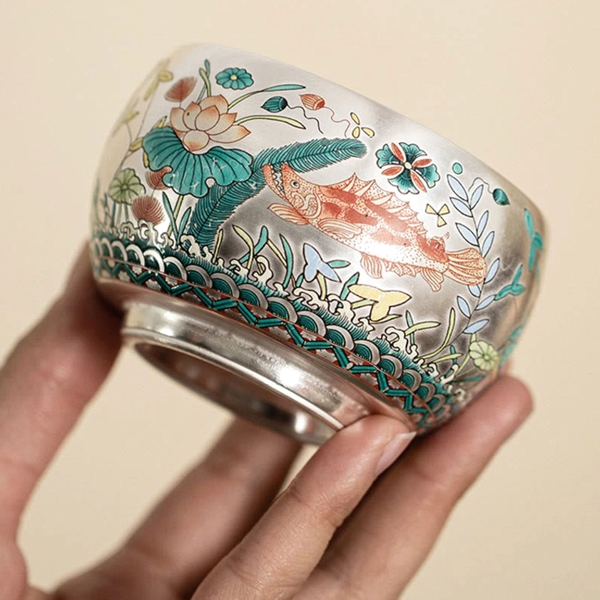 Buddhist ceramic kung fu tea cup with curved body and detailed aquatic floral-fish artwork side view