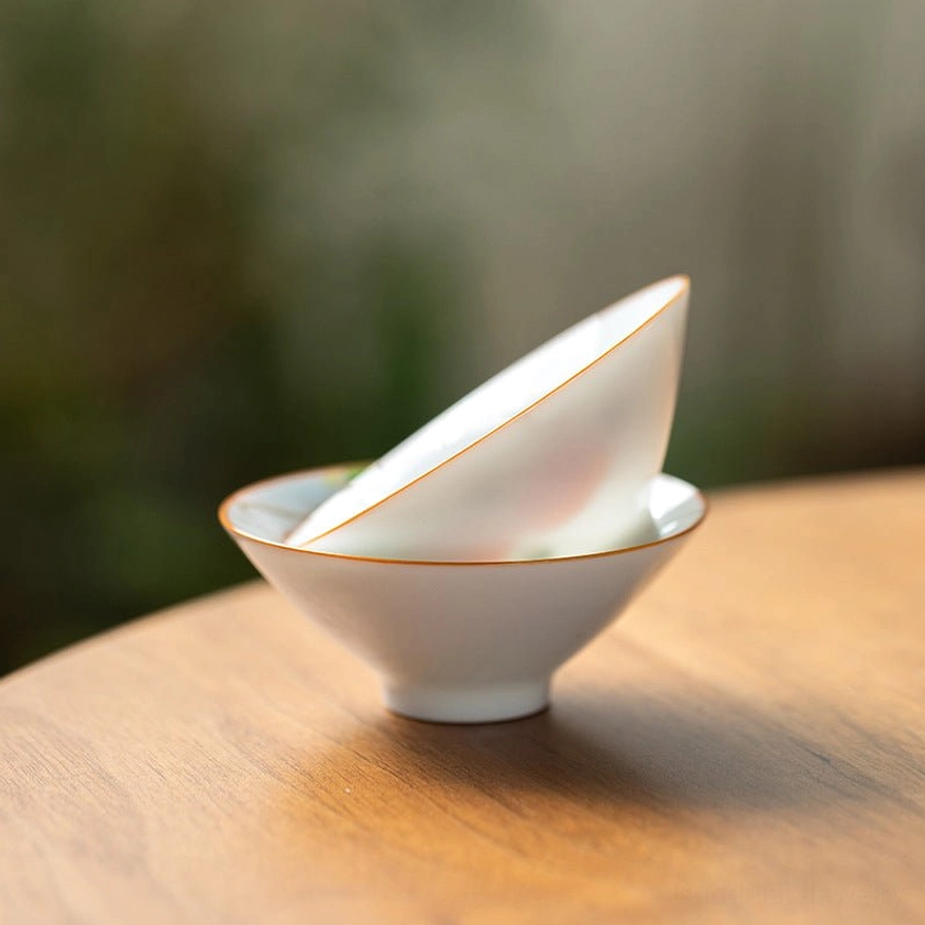 Authentic hand-painted Buddhist ceramic teacup detail view showing artistic craftsmanship