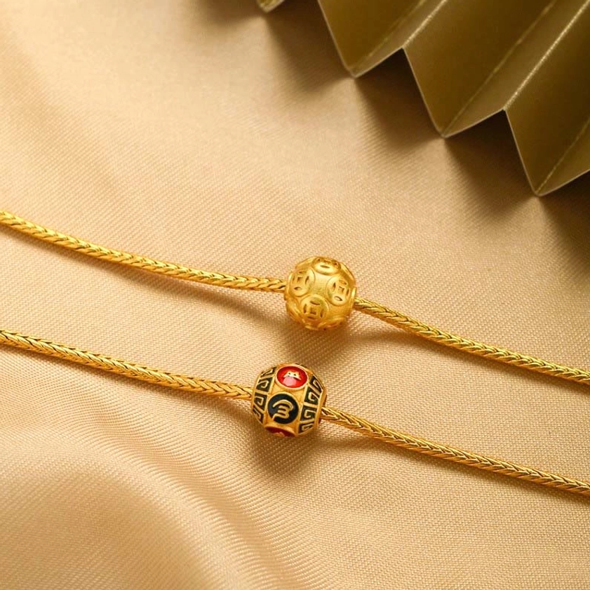Gold Buddhist bracelet with smooth bead and enamel mantra charm on twisted snake chain