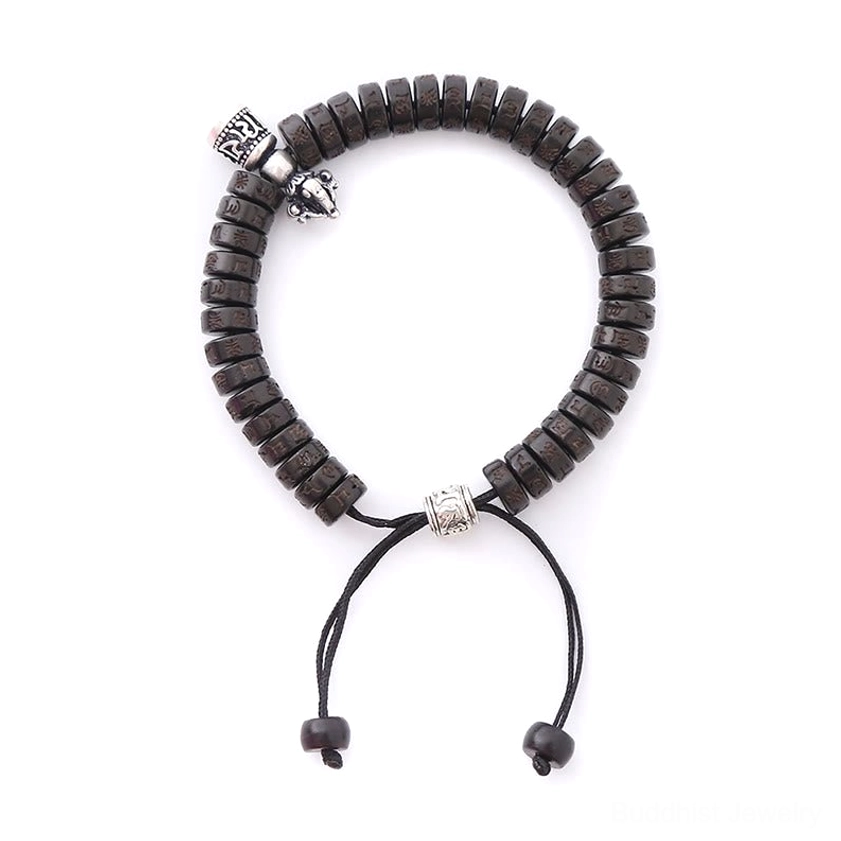 Buddhist prayer bracelet flat lay featuring natural coconut shell beads with engraved silver metal charms and pull knot closure