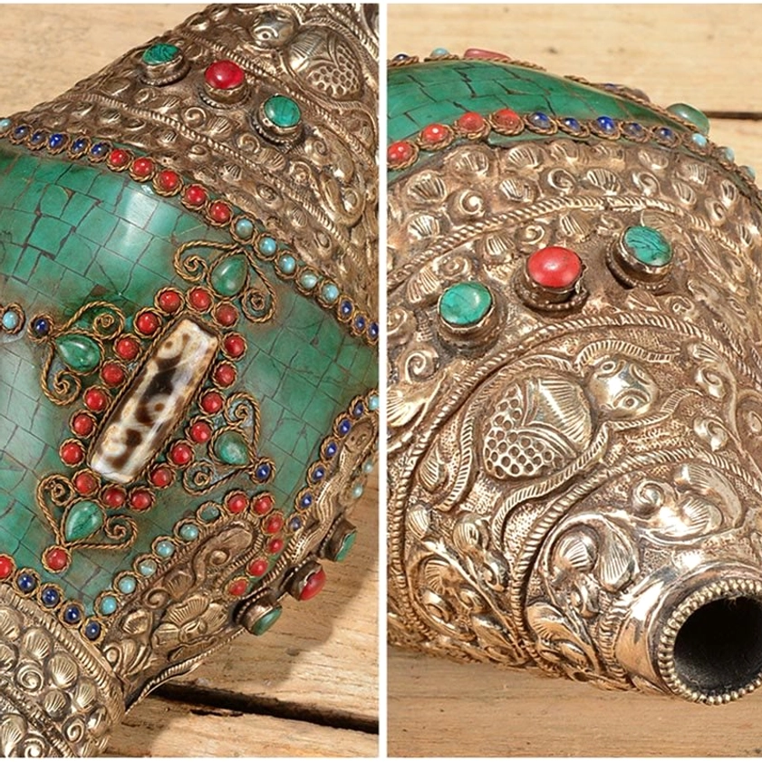 Close-up macro top view of Buddhist conch ornament decorative inlays, featuring red-green gemstone trims and turquoise mosaic with engraved silver floral patterns