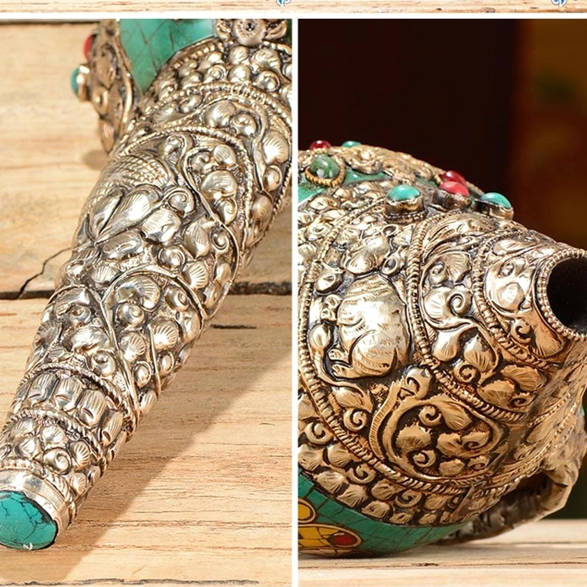 Detailed macro view of two Buddhist conch decorations showing silver animal and floral carvings with turquoise inlaid tips