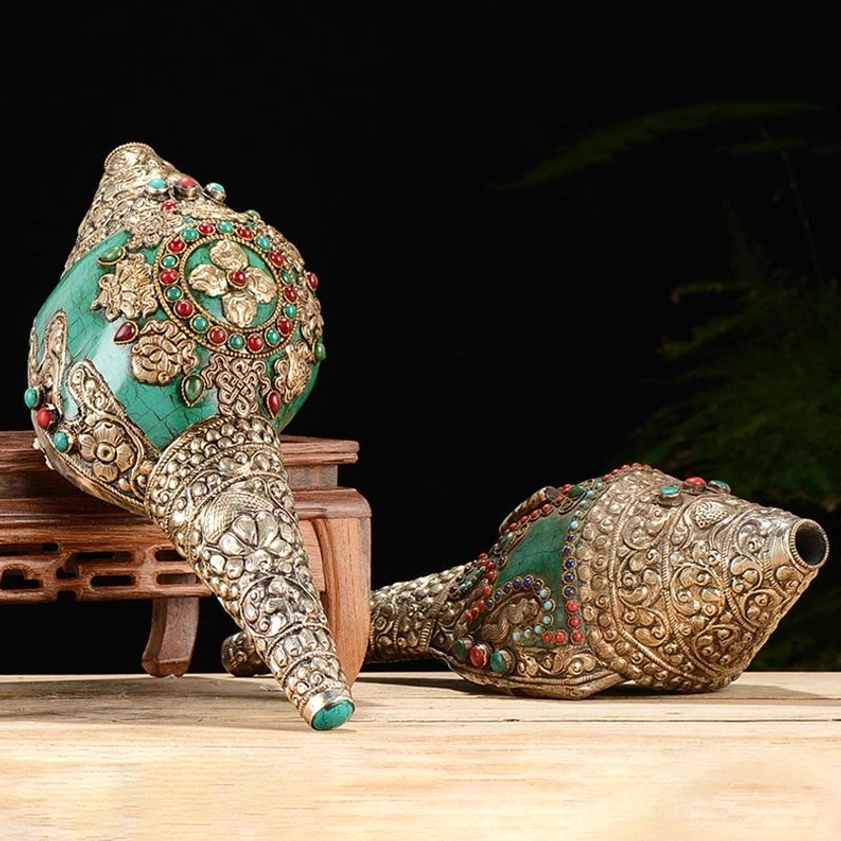 Handcrafted Buddhist Shankha conch shell decoration with silver engravings and turquoise inlay, displayed on wooden stand showing intricate dorje carving details