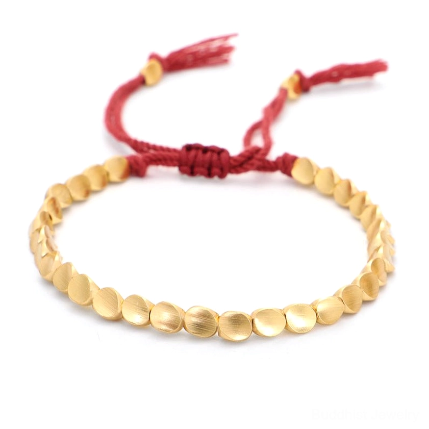 Handmade copper Buddhist bracelet with matte gold beads, solid red braided cord and red center knot