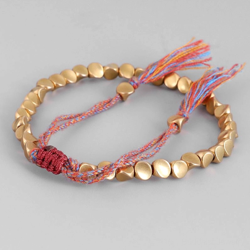 Copper Buddhist healing bracelet for meditation and spiritual practice with handwoven cord and tassels