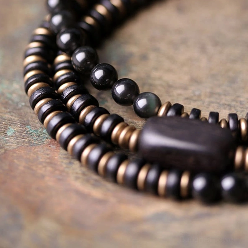 Buddhist inspired healing bracelet with rainbow obsidian, ebony wood, and copper for grounding and spiritual protection