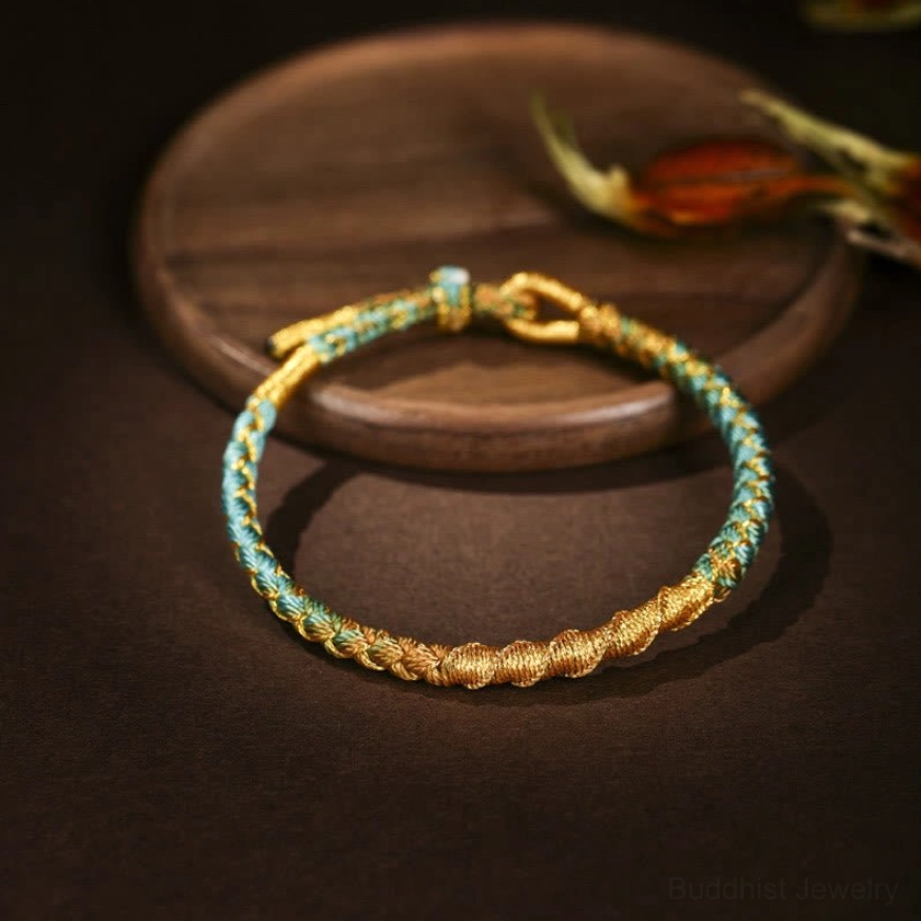 Cyan and gold handwoven Buddhist protection bracelet with dragon scale knot design adjustable clasp