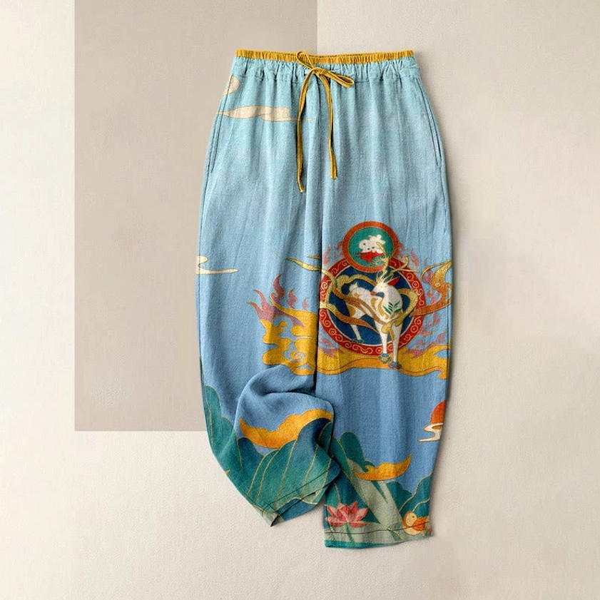 Women's cotton harem pants with Buddhist spiritual print in sky blue, flat lay showing elastic waist and pockets