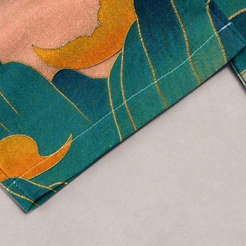 Close-up detail of sacred mountain and divine deer print on natural cotton fabric with teal and orange tones