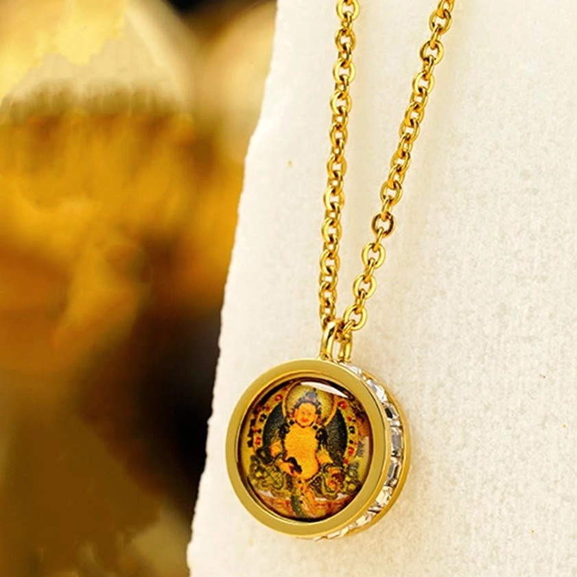 Buddhist necklace with deity artwork - round pendant with zirconia-trimmed gold frame on jewelry stand