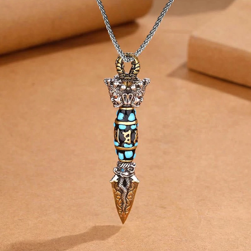 Buddhist dzi bead dorje pendant on keel chain necklace, top-front view showing hand-painted six-word mantra and mixed metal finish