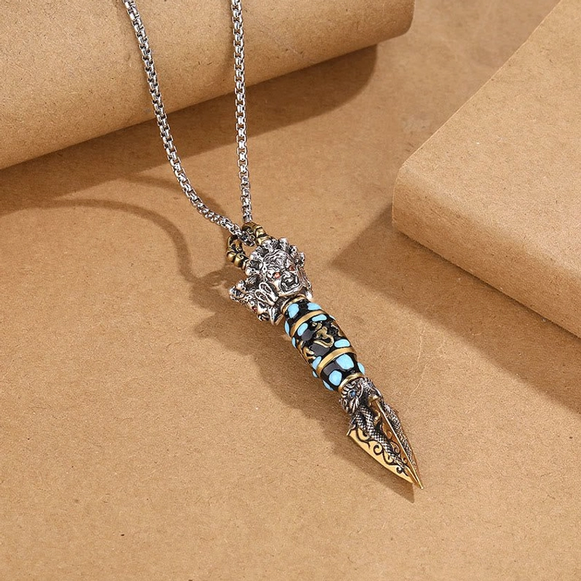 Buddhist Dorje Vajra pendant necklace with hand-carved dragon motifs and dzi bead, oblique angle view showing three-dimensional craftsmanship