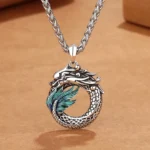 Buddhist dragon copper pendant necklace with bone chain, handmade antique silver finish, top-down close-up view on kraft paper