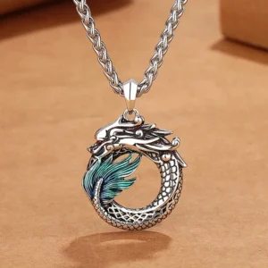 Buddhist dragon copper pendant necklace with bone chain, handmade antique silver finish, top-down close-up view on kraft paper