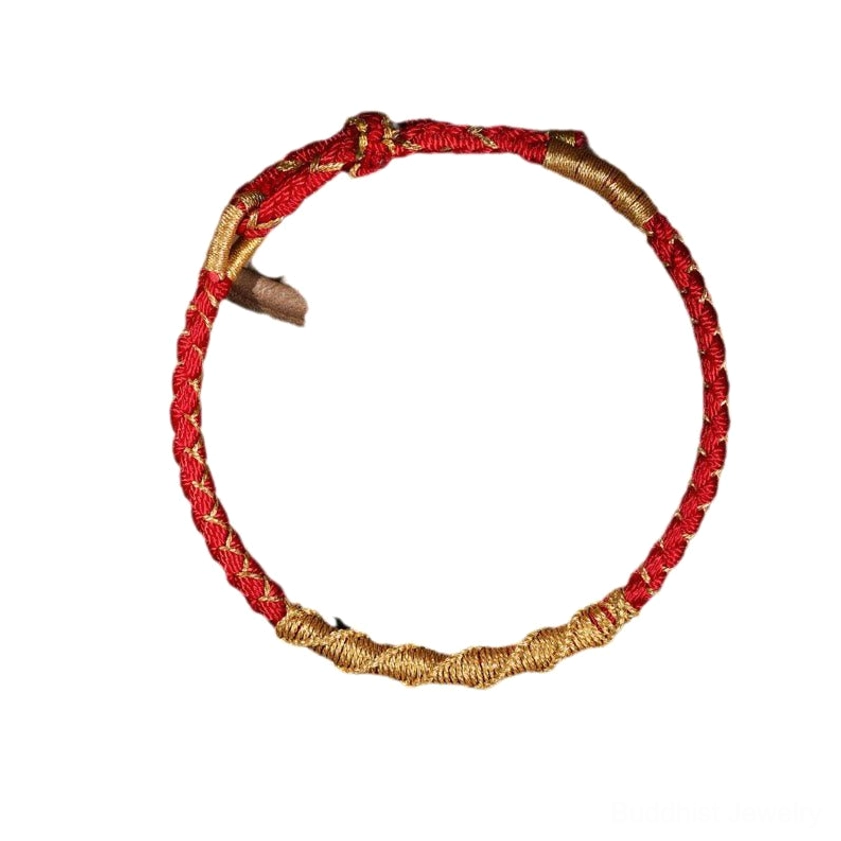 Red and gold braided Buddhist protection bracelet overhead view displaying twisted dragon scale weave pattern