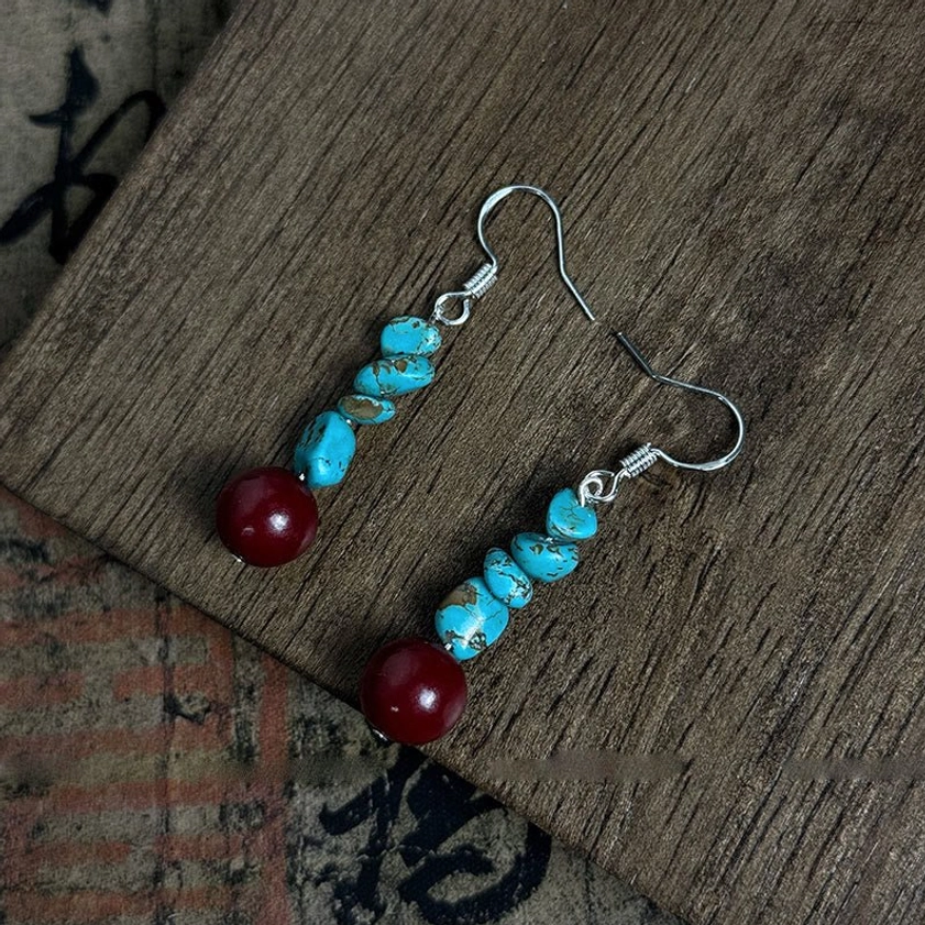 Side angle view of beaded turquoise and cinnabar drop earrings with 925 silver hardware