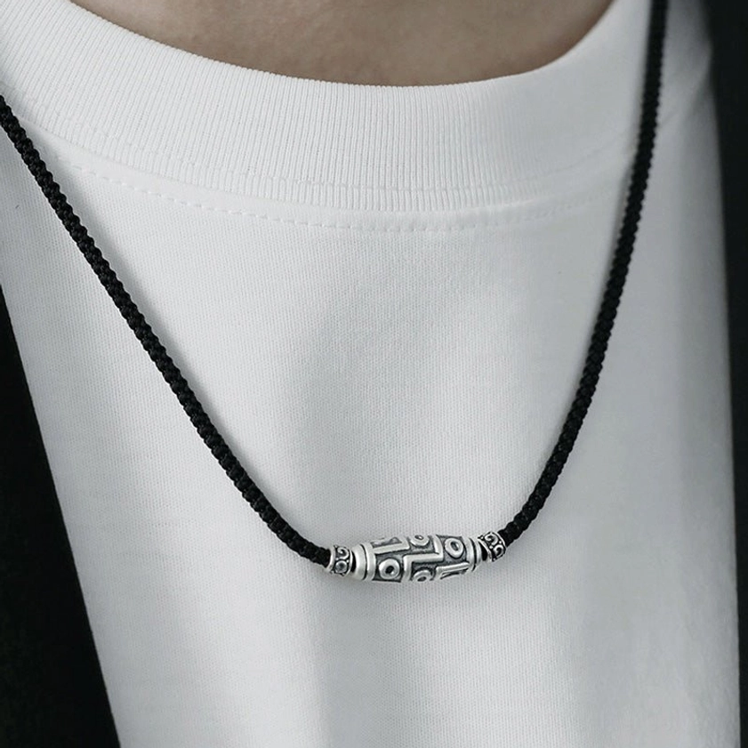 Buddhist nine-eye dzi necklace showing spiritual significance and protective amulet properties for meditation practice