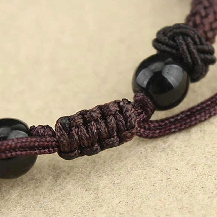 Buddhist Dzi bead protection necklace detail shot displaying hand-painted agate beads with cosmic symbolism and spiritual significance