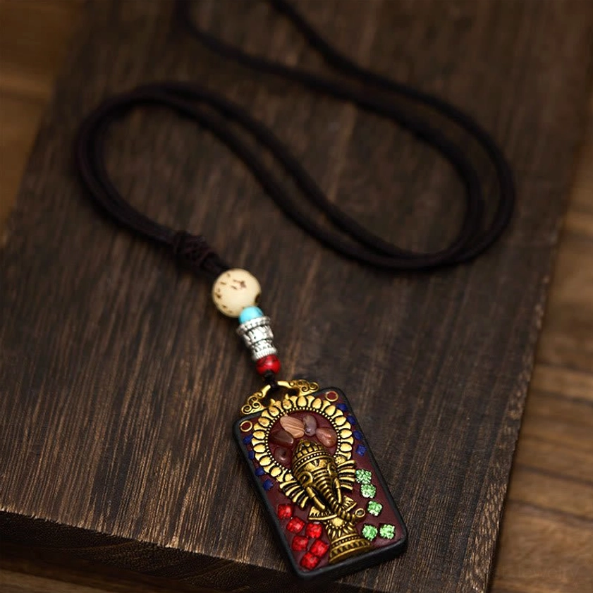 Buddhist elephant pendant necklace with spiritual symbolism and natural ebony wood