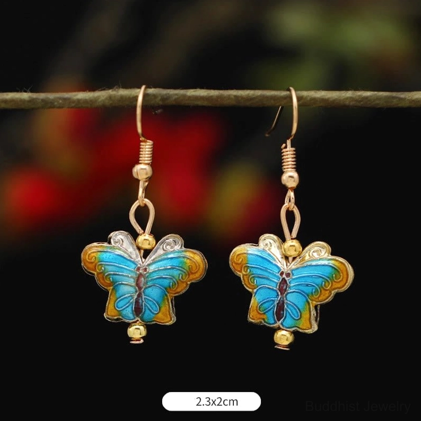 Handcrafted Buddhist enamel earrings detail view showing intricate lotus and butterfly workmanship