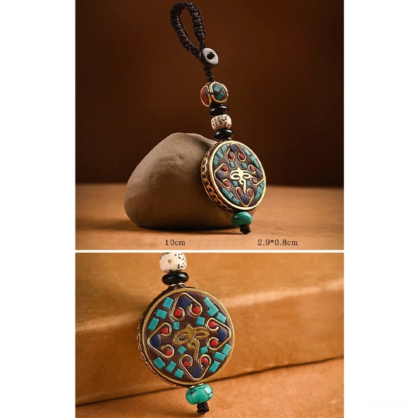 Buddhist eye-pattern keychain with eye motif brass pendant and enamel inlaid details, three-quarter view