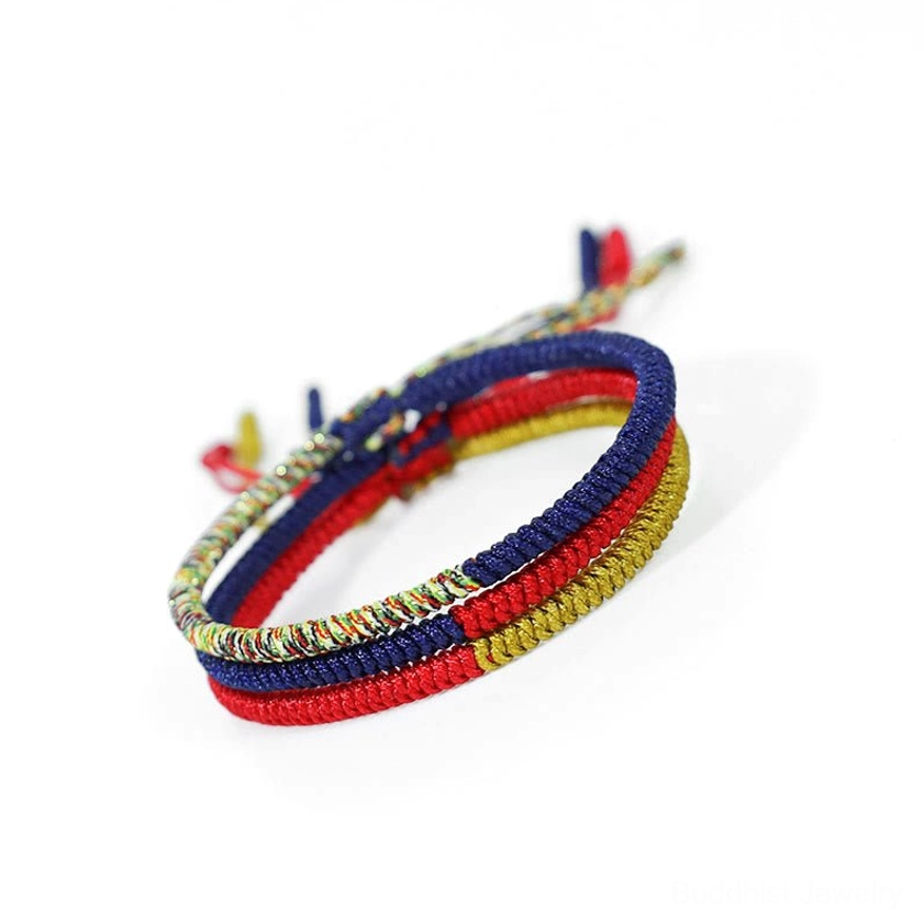 Sacred King Kong knot red and navy woven bracelet with decorative tassel and gold woven pattern
