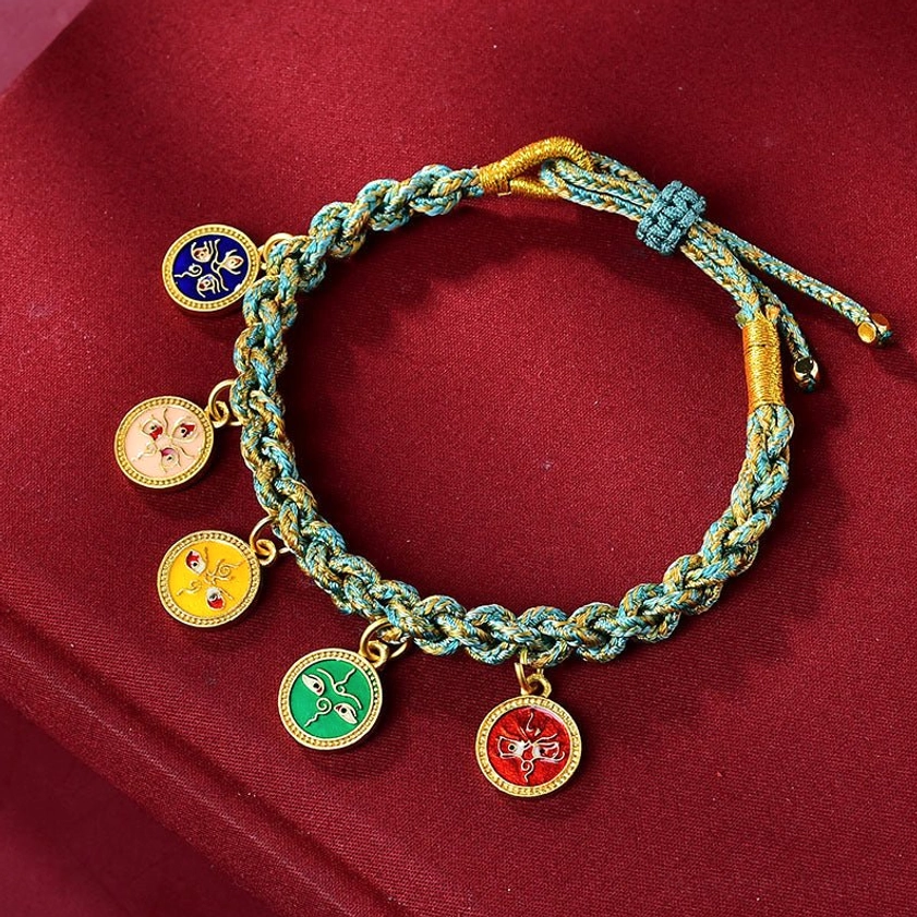 Buddhist five gods of wealth braided rope bracelet with cyan and yellow woven string and five enamel metal charms on burgundy velvet
