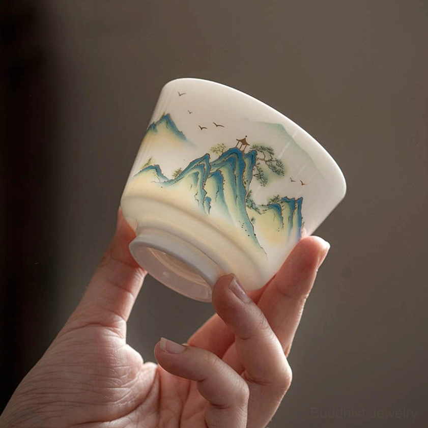 Artisan Buddhist porcelain tea cup featuring traditional hand-painted floral and nature motifs for peaceful tea drinking