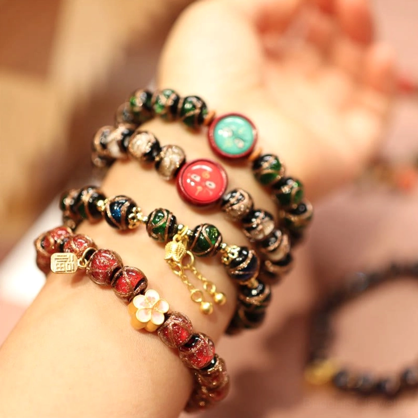 Buddhist prosperity bracelet collection with cloisonne charms, gold metal accents and gemstone beads lifestyle wear