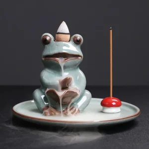 Handcrafted Buddhist frog backflow incense burner in celadon green ceramic with lotus design, frontal view showing ceramic texture and brown glazed details